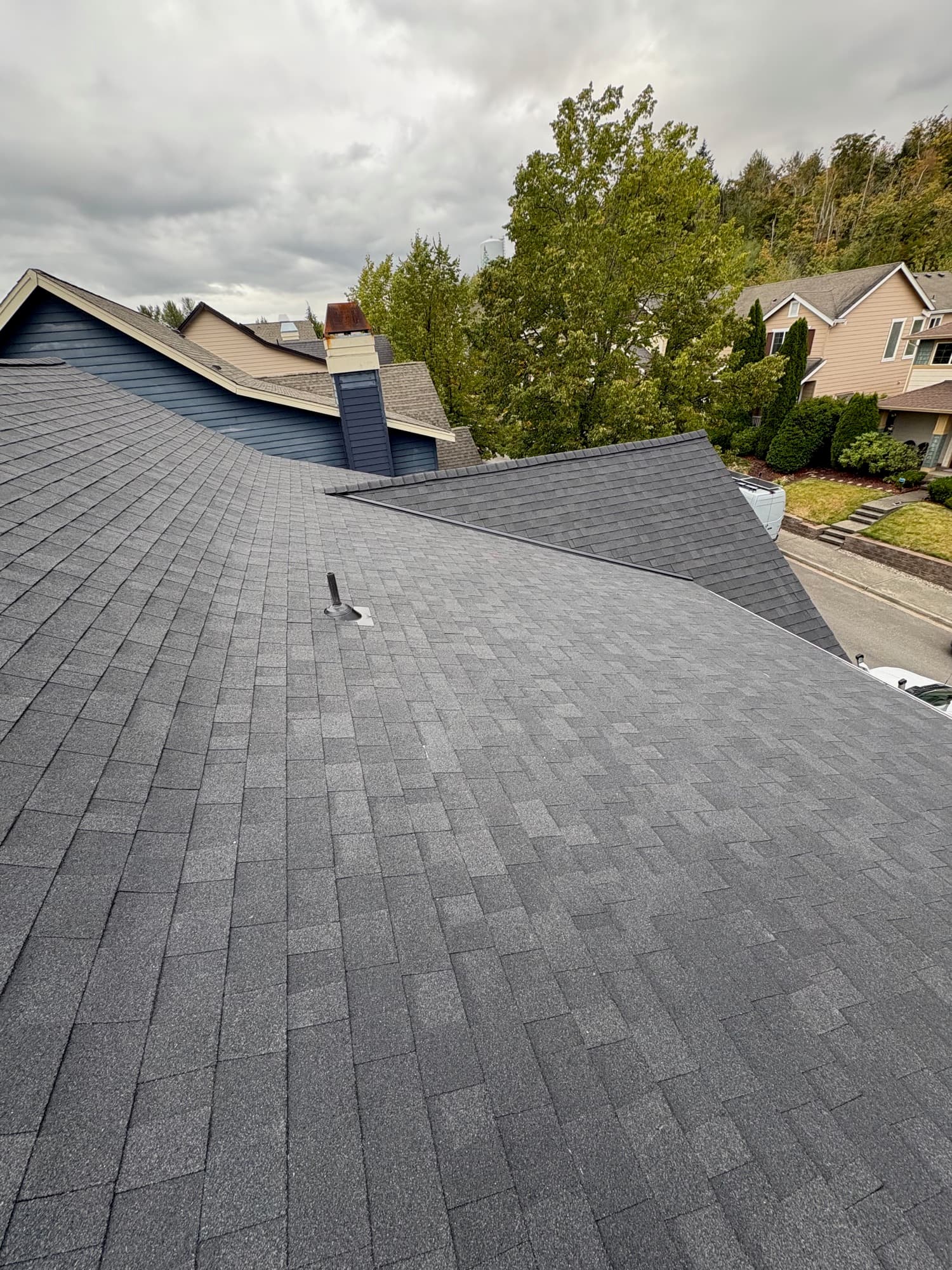 A large architectural asphalt shingle roof with hips and closed-cut valleys, completed by Best Pro Contractors