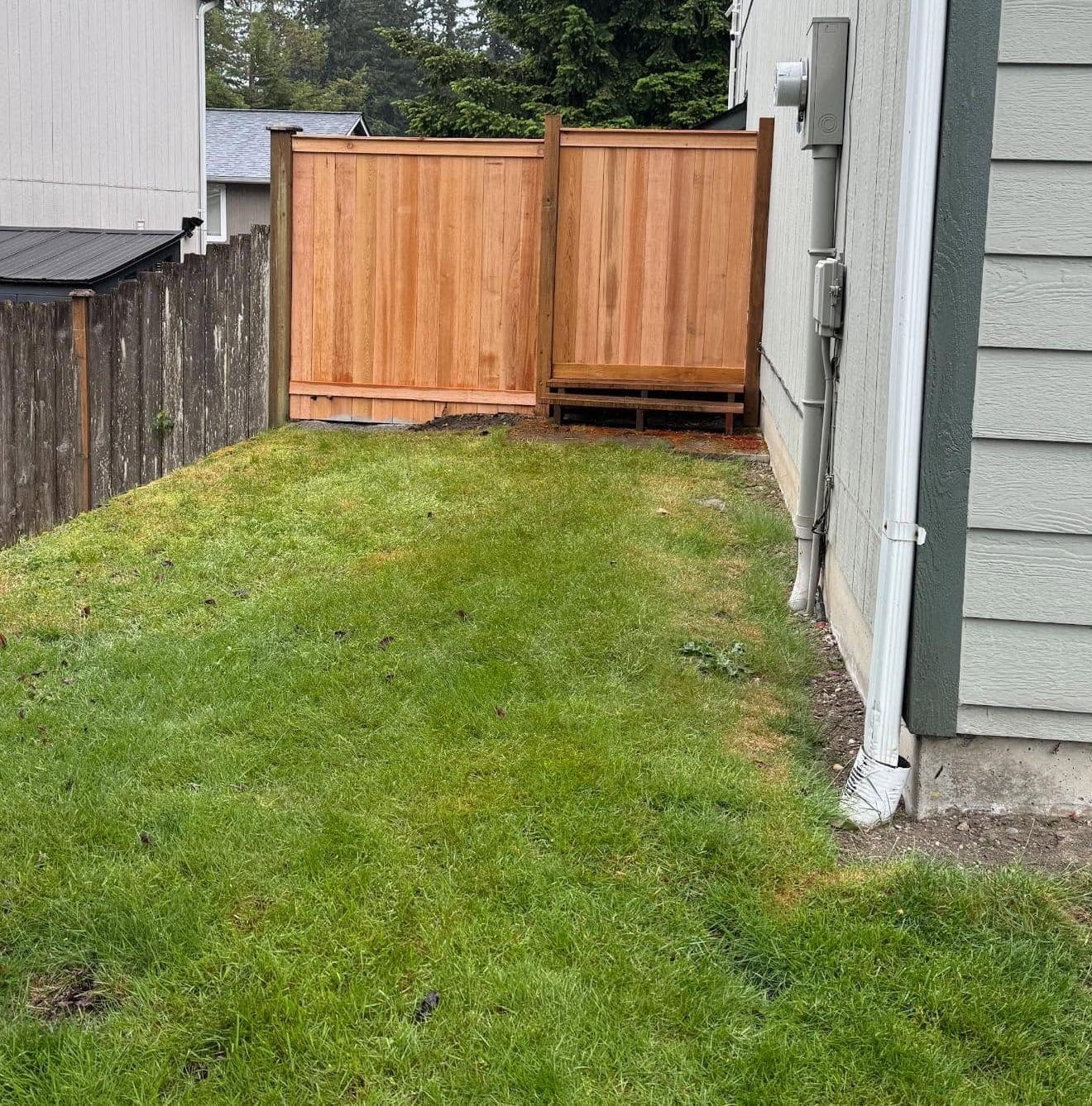 New cedar privacy fence along a side yard, built by Best Pro Contractors
