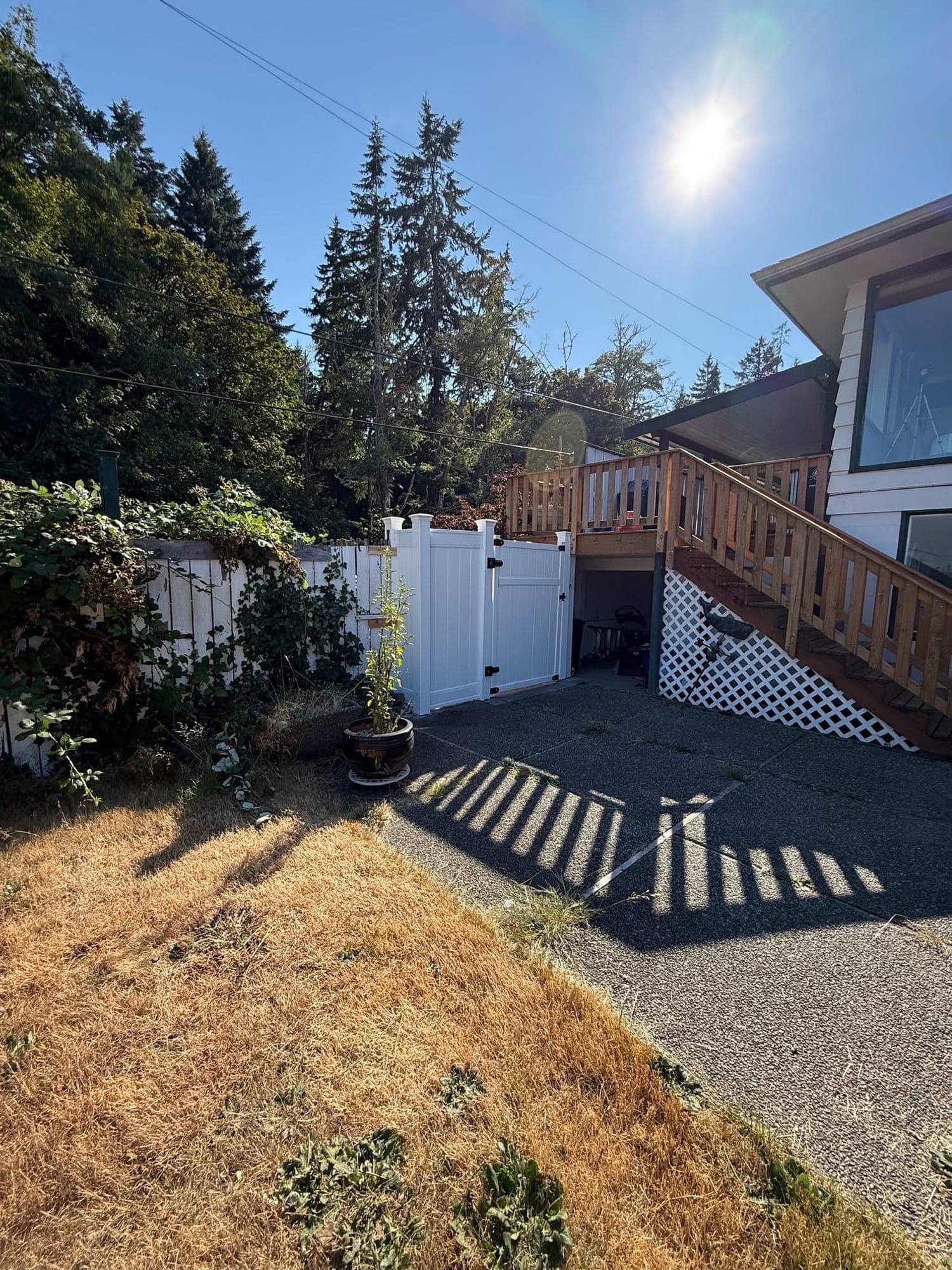 White vinyl privacy fence with a matching walk gate, installed by Best Pro Contractors
